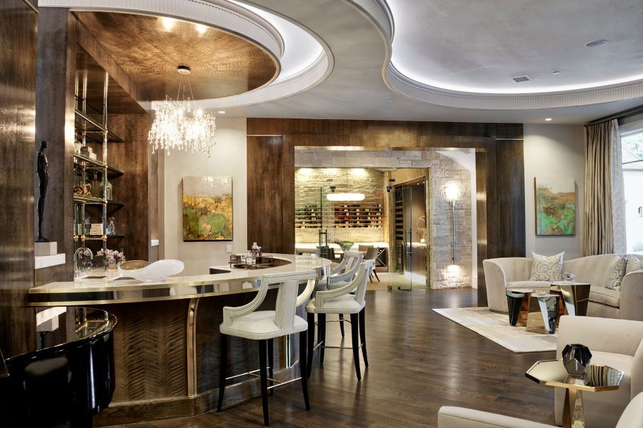 A beautifully illuminated home entertainment space with a bar, wine-tasting area, and a piano.