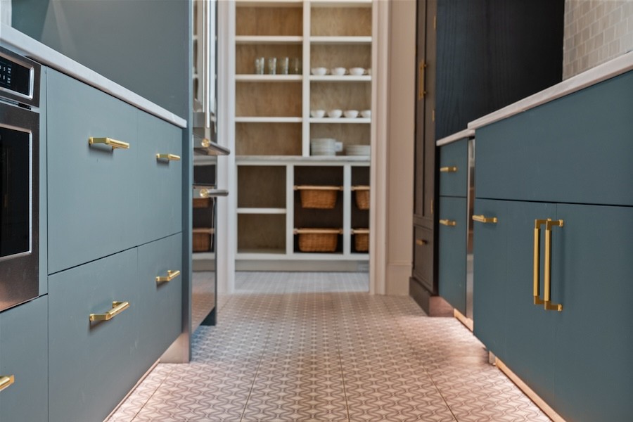 A kitchen with invisible toe-kick lighting under cabinets.