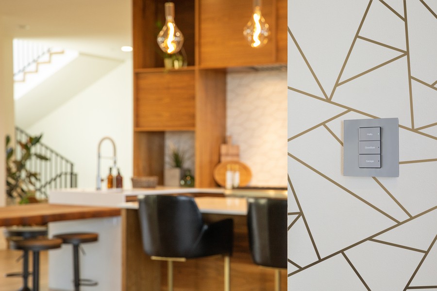 A smart lighting wall keypad with warm LED lighting illuminating a kitchen.