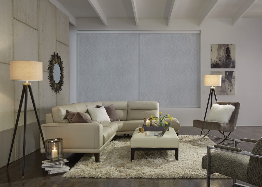 Modern living space with Lutron motorized shades lowered on windows.