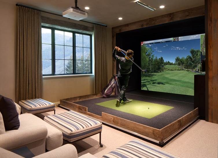 Man using a home golf simulator in the home theater.