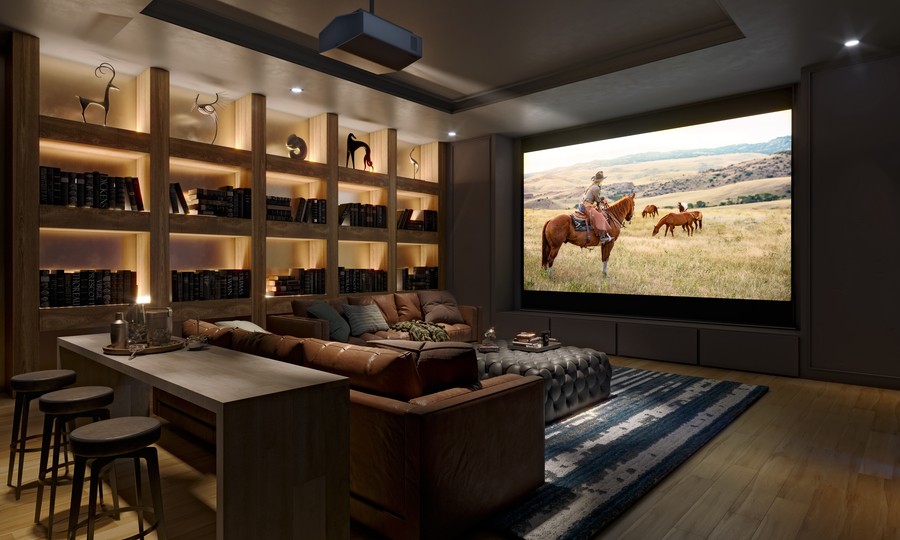 Luxury home theater with a Sony projector, linear-lit bookshelf, and high-top table at the back of the room.